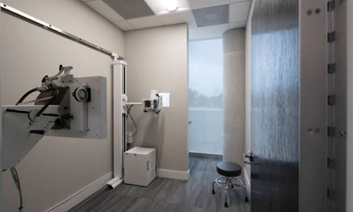 Private treatment room with wall-mounted clinical equipment